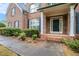Inviting front entrance with brick walkway and meticulously landscaped shrubbery at 732 Sweet Gum Way, Canton, GA 30115