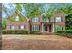 Two-story brick home with dark shutters and a covered front porch framed by white columns at 732 Sweet Gum Way, Canton, GA 30115