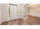 Bright entryway with wood flooring, a tray ceiling, and a view into the adjacent dining room at 732 Sweet Gum Way, Canton, GA 30115