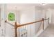 Bright hallway with hardwood railing and large arched window providing natural light at 732 Sweet Gum Way, Canton, GA 30115