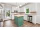 Bright kitchen featuring a stylish green island and stainless-steel appliances, with eat-in nook at 732 Sweet Gum Way, Canton, GA 30115