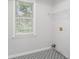 Laundry room features a window, patterned floors, and shelving at 732 Sweet Gum Way, Canton, GA 30115