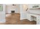 Open living space with fireplace adjacent to built-in office space and kitchen at 732 Sweet Gum Way, Canton, GA 30115