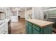Open-concept living space with fireplace and views of kitchen with center green island at 732 Sweet Gum Way, Canton, GA 30115