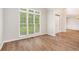 Sun-filled living room featuring wood floors and large windows with backyard views at 732 Sweet Gum Way, Canton, GA 30115