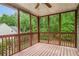 Back porch with wooded views and ceiling fan, surrounded by lush trees at 732 Sweet Gum Way, Canton, GA 30115