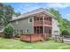 View of the back of the house with a multi-level screened porch and wood deck overlooking a large grassy yard at 732 Sweet Gum Way, Canton, GA 30115