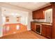 Wet bar adjacent to basement living room features cabinetry, sink, beverage cooler, and granite countertop at 732 Sweet Gum Way, Canton, GA 30115