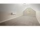 Finished attic room with plush carpet and a window, providing a versatile space at 74 Stonegate Ct, Dallas, GA 30157