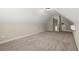 Finished attic room with neutral carpet, offering potential as a bonus or storage area at 74 Stonegate Ct, Dallas, GA 30157