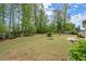 Spacious backyard with a lush lawn, complemented by trees and a patio, providing an ideal setting for outdoor enjoyment at 74 Stonegate Ct, Dallas, GA 30157