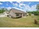 Large backyard featuring green grass and mature trees, offering a serene outdoor setting for leisure and recreation at 74 Stonegate Ct, Dallas, GA 30157