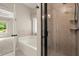 Bright bathroom featuring a soaking tub, tile flooring, and a glass-enclosed walk-in shower at 74 Stonegate Ct, Dallas, GA 30157