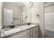 Bathroom featuring granite countertops, double sinks, and a well-lit mirror above white cabinetry at 74 Stonegate Ct, Dallas, GA 30157