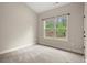 Bright bedroom with a neutral color palette and a window overlooking a green, wooded area at 74 Stonegate Ct, Dallas, GA 30157