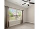 Bedroom with large window, gray carpet, and ceiling fan, creating a serene and comfortable atmosphere at 74 Stonegate Ct, Dallas, GA 30157