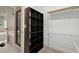 Walk-in closet featuring wire shelving, dark brown shelving unit and open door to bathroom at 74 Stonegate Ct, Dallas, GA 30157