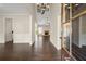 Elegant foyer features dark hardwood floors, a chandelier, and an open view of the living room at 74 Stonegate Ct, Dallas, GA 30157