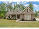 Charming single-story home with well-manicured lawn, complemented by mature trees and a welcoming entrance at 74 Stonegate Ct, Dallas, GA 30157