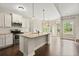 Modern kitchen features stainless steel appliances, an island with granite countertops, and an eat-in area at 74 Stonegate Ct, Dallas, GA 30157