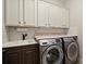 Well-equipped laundry room with modern washer and dryer, sink and cabinet space at 74 Stonegate Ct, Dallas, GA 30157