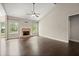 Bright living room featuring dark hardwood floors, a brick fireplace, and large windows with natural light at 74 Stonegate Ct, Dallas, GA 30157