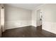 Empty dining area with dark wood floors, wainscoting and natural light from the window at 74 Stonegate Ct, Dallas, GA 30157