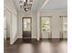 Light-filled living room with dark wood floors, large windows, and classic wall paneling at 74 Stonegate Ct, Dallas, GA 30157