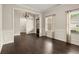 Light-filled living area with dark wood floors, wainscoting, and natural light from the large window at 74 Stonegate Ct, Dallas, GA 30157