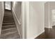 Carpeted stairs adjacent to hardwood floors create a seamless transition in the home's design at 74 Stonegate Ct, Dallas, GA 30157