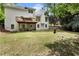 Expansive backyard with a spacious deck, lush green lawn and tree coverage at 1725 Redbud Way, Cumming, GA 30041