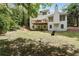 Lush backyard featuring a deck, mature trees, and a well-maintained lawn, great for outdoor activities at 1725 Redbud Way, Cumming, GA 30041