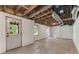 Unfinished basement space with exposed ceiling, large windows, and access to the outdoors at 1725 Redbud Way, Cumming, GA 30041