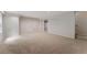 Unfinished basement features neutral carpeting, recessed lighting, and white walls at 1725 Redbud Way, Cumming, GA 30041