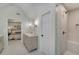 This luxury bathroom features a double vanity, stylish lighting, glass shower, and access to the main bedroom at 1725 Redbud Way, Cumming, GA 30041
