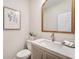 Stylish half-bathroom features modern vanity, mirror, and decor at 1725 Redbud Way, Cumming, GA 30041