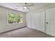 View of a bedroom with a ceiling fan, double window, closet, and carpet at 1725 Redbud Way, Cumming, GA 30041