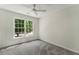 This empty bedroom has a large window for ample natural light and a ceiling fan at 1725 Redbud Way, Cumming, GA 30041