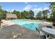 Large community swimming pool, surrounded by lounge chairs and lush greenery on a sunny day at 1725 Redbud Way, Cumming, GA 30041