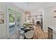 Open dining area with french doors, modern chandelier and a view of the kitchen at 1725 Redbud Way, Cumming, GA 30041