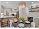 Bright dining area featuring stylish light fixture and open to updated kitchen at 1725 Redbud Way, Cumming, GA 30041