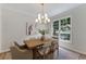 Dining room with hardwood flooring, area rug, and decorative light fixture at 1725 Redbud Way, Cumming, GA 30041