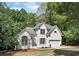 Charming two-story painted brick home with a well-manicured lawn and mature trees at 1725 Redbud Way, Cumming, GA 30041