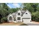 Charming two-story painted brick home with a well-manicured lawn and mature trees at 1725 Redbud Way, Cumming, GA 30041