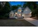 Charming two-story traditional home with a manicured lawn and a two-car garage, set amongst mature trees at 1725 Redbud Way, Cumming, GA 30041