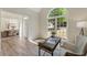 Inviting home office featuring an arched window, hardwood floors, and soft natural lighting at 1725 Redbud Way, Cumming, GA 30041