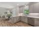 Bright kitchen offers stainless steel appliances, white cabinets, wood flooring, and an open floorplan at 1725 Redbud Way, Cumming, GA 30041