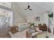Living room with fireplace, staircase, hardwood floors, and vaulted ceiling at 1725 Redbud Way, Cumming, GA 30041
