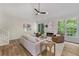 Living room with vaulted ceiling, hardwood floors, fireplace, and large windows at 1725 Redbud Way, Cumming, GA 30041