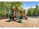 Community playground featuring wood structures and slides, surrounded by lush trees, perfect for ' playtime at 1725 Redbud Way, Cumming, GA 30041